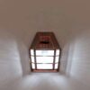 wood framed lantern style light fixture reminiscen